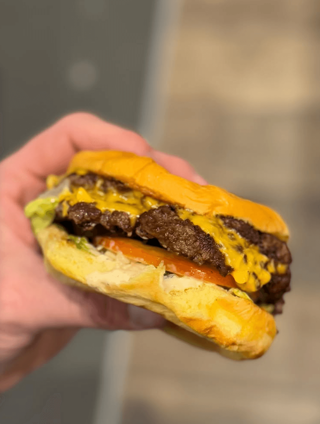 All American Smash burger with melted cheese, lettuce, and tomato